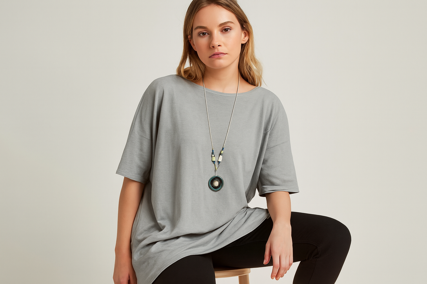 Seated pose with realistic fabric texture and green pendant necklace